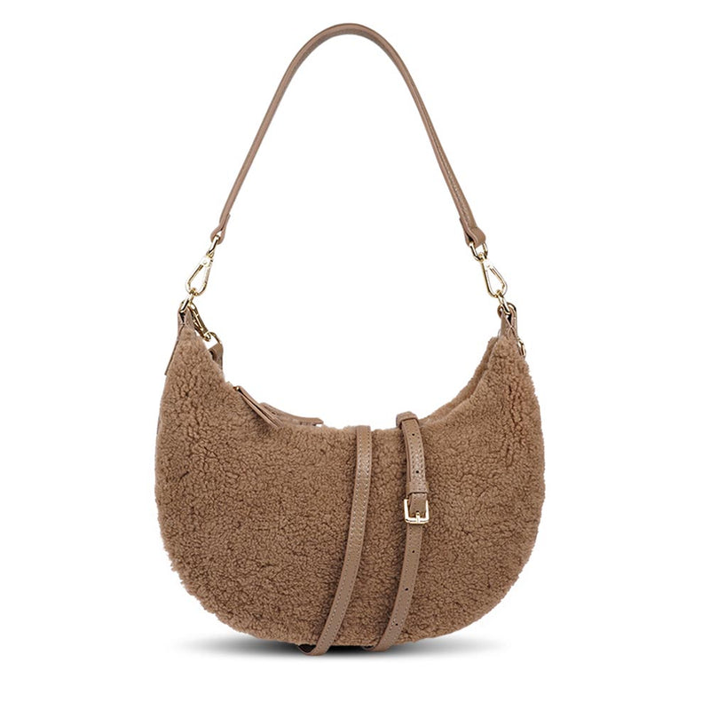 Kangmar is a beautiful shearling handbag which is perfect for carrying your essentials with you, it comes with detachable shoulder strap in skin. Top double zipped closure. Top handle in soft skin with hardware in gold. Adjustable and detachable shoulder strap in leather, 15 mm wide.  Satin lining and flat zipped inner pocket Item comes with a branded dust bag. Embossed Lovelies logo inside the bag.  Gold-toned hardware Measurements W36 X D5 X H20 cm 100 % Australian shearling 