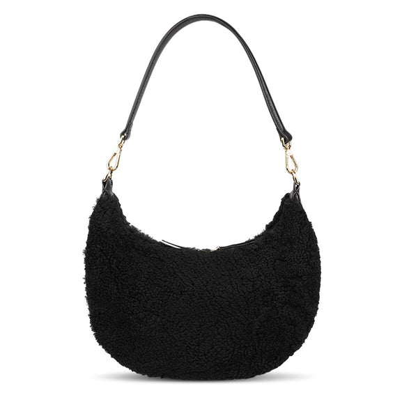 Kangmar is a beautiful shearling handbag which is perfect for carrying your essentials with you, it comes with detachable shoulder strap in skin. Top double zipped closure. Top handle in soft skin with hardware in gold. Adjustable and detachable shoulder strap in leather, 15 mm wide.  Satin lining and flat zipped inner pocket Item comes with a branded dust bag. Embossed Lovelies logo inside the bag.  Gold-toned hardware Measurements W36 X D5 X H20 cm 100 % Australian shearling 