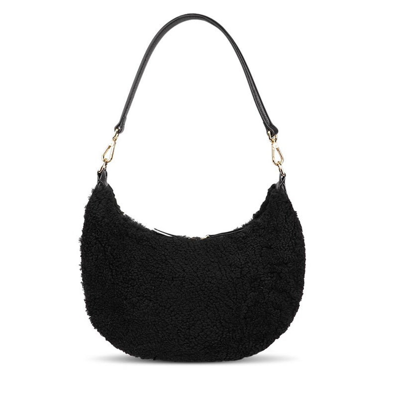 Kangmar is a beautiful shearling handbag which is perfect for carrying your essentials with you, it comes with detachable shoulder strap in skin. Top double zipped closure. Top handle in soft skin with hardware in gold. Adjustable and detachable shoulder strap in leather, 15 mm wide.  Satin lining and flat zipped inner pocket Item comes with a branded dust bag. Embossed Lovelies logo inside the bag.  Gold-toned hardware Measurements W36 X D5 X H20 cm 100 % Australian shearling 