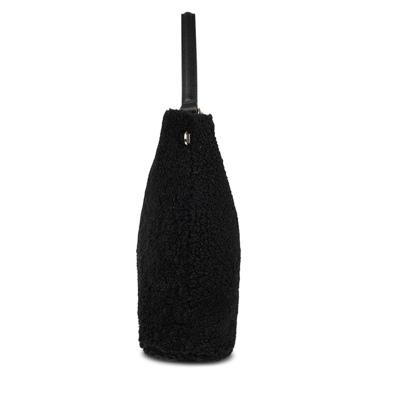 Mainling is a tribute to craftsmanship and the handmade, this large and very soft bag comes in curly shearling and with beautiful leather details. * Top double zipped closure. * Top handle in soft skin with hardware in gold. * Adjustable and detachable shoulder strap in leather, 15 mm wide. * Satin lining and flat zipped inner pocket * Item comes with a branded dust bag. * Embossed Lovelies logo on the front. * Gold-toned hardware * Messurements W40 X D10 X H30 cm * 100 % Australian shearling