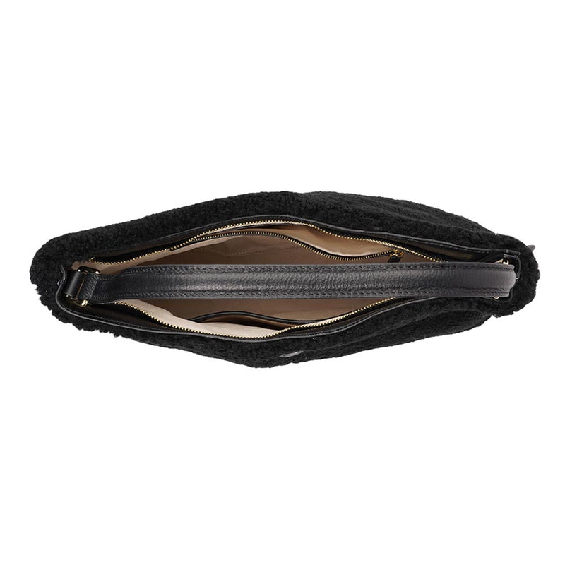 Mainling is a tribute to craftsmanship and the handmade, this large and very soft bag comes in curly shearling and with beautiful leather details. * Top double zipped closure. * Top handle in soft skin with hardware in gold. * Adjustable and detachable shoulder strap in leather, 15 mm wide. * Satin lining and flat zipped inner pocket * Item comes with a branded dust bag. * Embossed Lovelies logo on the front. * Gold-toned hardware * Messurements W40 X D10 X H30 cm * 100 % Australian shearling