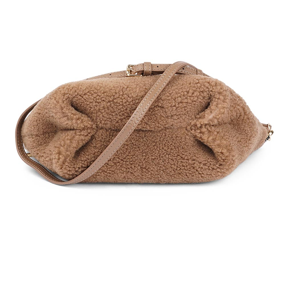 Rawu is a cool shearling clutch which is perfect for carrying your essentials with you. Rawu is hand made from the finest curly shearling from Australia * Top magnet closing * Detachable wrist strap * Adjustable and detachable shoulder strap in leather (15 mm) * Skin lining and flat zipped inner pocket * Item comes with a branded dust bag. * Embossed Lovelies logo on the front. * Gold-toned hardware * Messurements W30 X D12 X H18 cm * 100 % Australian shearling.