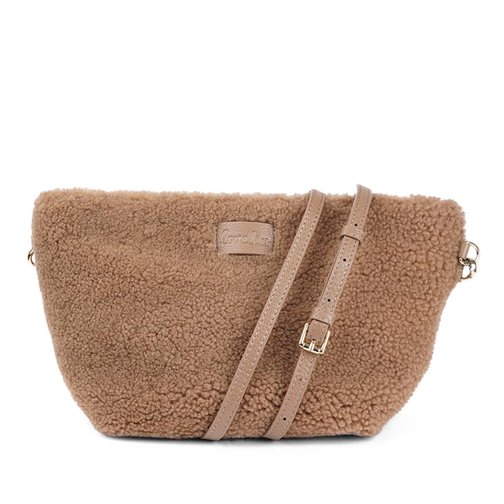 Rawu is a cool shearling clutch which is perfect for carrying your essentials with you. Rawu is hand made from the finest curly shearling from Australia * Top magnet closing * Detachable wrist strap * Adjustable and detachable shoulder strap in leather (15 mm) * Skin lining and flat zipped inner pocket * Item comes with a branded dust bag. * Embossed Lovelies logo on the front. * Gold-toned hardware * Messurements W30 X D12 X H18 cm * 100 % Australian shearling.