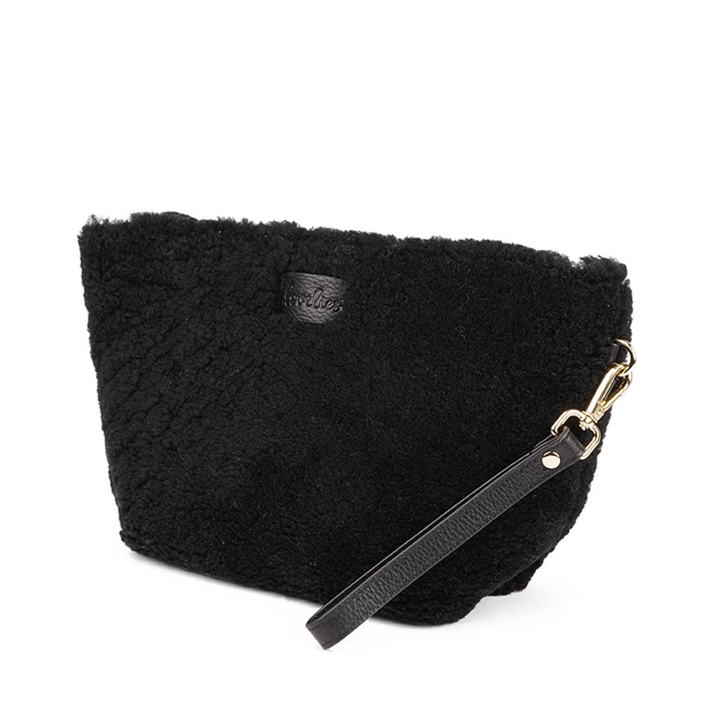 Rawu is a cool shearling clutch which is perfect for carrying your essentials with you. Rawu is hand made from the finest curly shearling from Australia * Top magnet closing * Detachable wrist strap * Adjustable and detachable shoulder strap in leather (15 mm) * Skin lining and flat zipped inner pocket * Item comes with a branded dust bag. * Embossed Lovelies logo on the front. * Gold-toned hardware * Messurements W30 X D12 X H18 cm * 100 % Australian shearling.