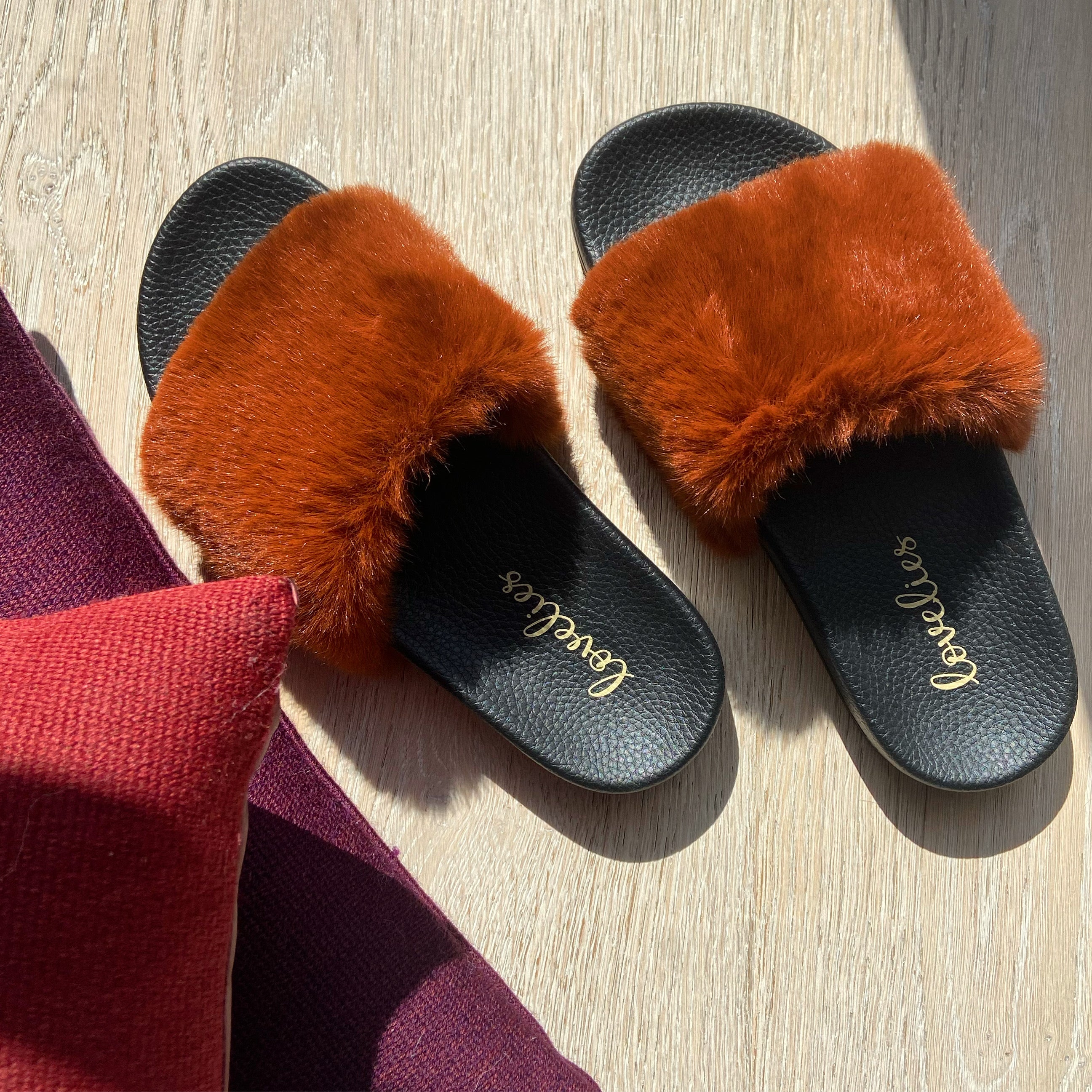 Lovelies Studio Denmark -  Exclusive slides with faux fur. Beautiful and feminine faux fur slides.  The soft rubber sole is light and very comfortable.   We are proud member of 1% for the planet  Enjoy your Lovelies  Material:  Sole : PU   Rubber Lining: Cotton Upper: Faux fur Summer slides in black and rust