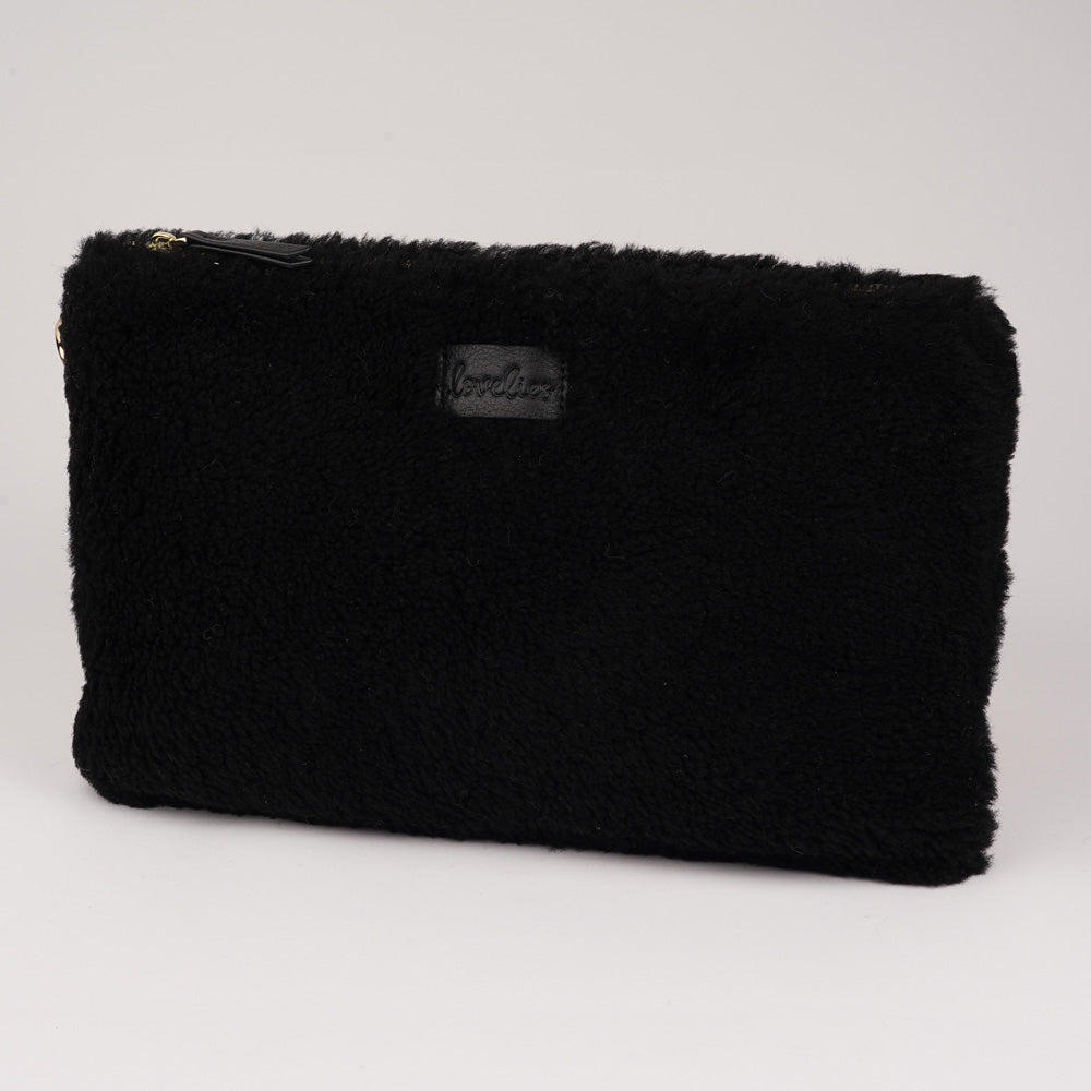 Lovelies Studio Wujii is a large shearling clutch which has room enough for your Ipad and notebooks . Wujii is hand made from the finest curly shearling from Australia.  Top zipped closing   Detachable wrist strap   Satin lining and flat zipped inner pocket   Item comes with a branded dust bag.   Embossed Lovelies logo on the front   Gold-toned hardware   Measurements W34 X D2 X H22 cm   100 % Australian curly shearling 