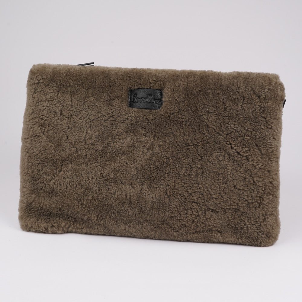 Lovelies Studio Wujii is a large shearling clutch which has room enough for your Ipad and notebooks . Wujii is hand made from the finest curly shearling from Australia.  Top zipped closing   Detachable wrist strap   Satin lining and flat zipped inner pocket   Item comes with a branded dust bag.   Embossed Lovelies logo on the front   Gold-toned hardware   Measurements W34 X D2 X H22 cm   100 % Australian curly shearling 