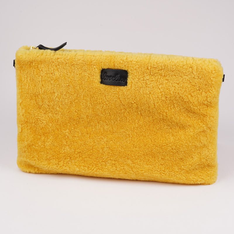 Lovelies Studio Wujii is a large shearling clutch which has room enough for your Ipad and notebooks . Wujii is hand made from the finest curly shearling from Australia.  Top zipped closing   Detachable wrist strap   Satin lining and flat zipped inner pocket   Item comes with a branded dust bag.   Embossed Lovelies logo on the front   Gold-toned hardware   Measurements W34 X D2 X H22 cm   100 % Australian curly shearling 