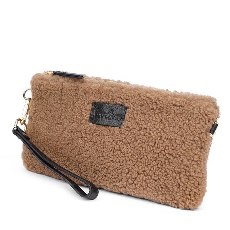 Lovelies Studio _ Wuttu is a mini clutch with a detachable wrist strap and is perfect for carrying your essentials with you. Wuttu is hand made from the finest curly shearling from Australia.   Top zipped closing   Detachable wrist strap   Satin lining and flat zipped inner pocket   Item comes with a branded dust bag.   Embossed Lovelies logo on the front   Gold-toned hardware   Measurements W26 X D2 X H12 cm   100 % Australian curly shearling 
