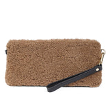 Lovelies Studio _ Wuttu is a mini clutch with a detachable wrist strap and is perfect for carrying your essentials with you. Wuttu is hand made from the finest curly shearling from Australia.   Top zipped closing   Detachable wrist strap   Satin lining and flat zipped inner pocket   Item comes with a branded dust bag.   Embossed Lovelies logo on the front   Gold-toned hardware   Measurements W26 X D2 X H12 cm   100 % Australian curly shearling 