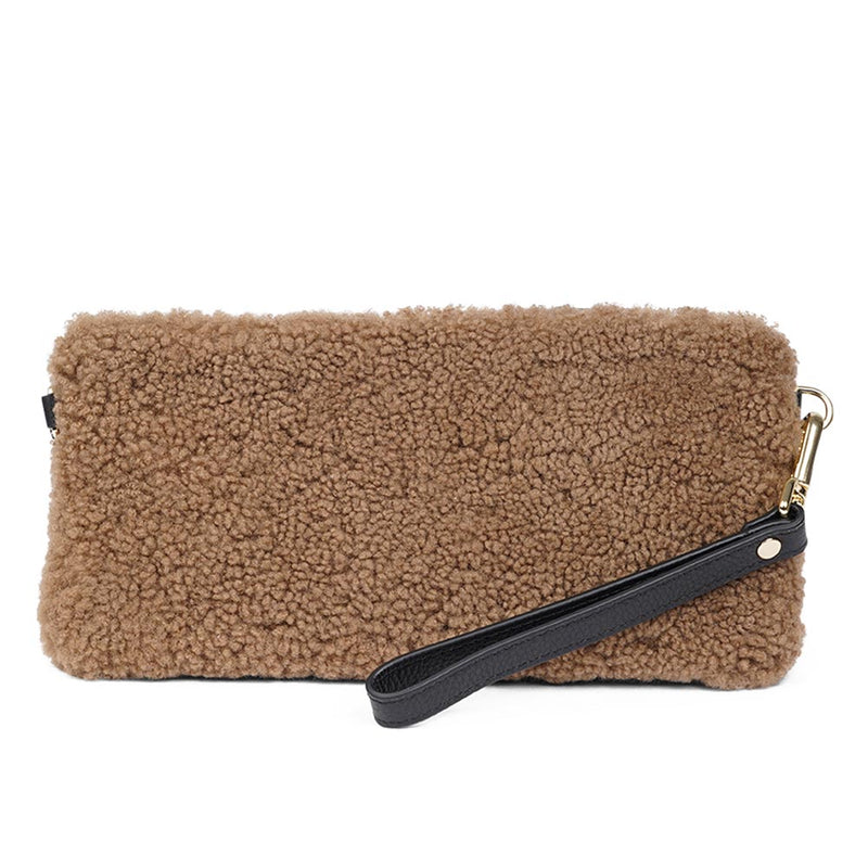 Lovelies Studio _ Wuttu is a mini clutch with a detachable wrist strap and is perfect for carrying your essentials with you. Wuttu is hand made from the finest curly shearling from Australia.   Top zipped closing   Detachable wrist strap   Satin lining and flat zipped inner pocket   Item comes with a branded dust bag.   Embossed Lovelies logo on the front   Gold-toned hardware   Measurements W26 X D2 X H12 cm   100 % Australian curly shearling 
