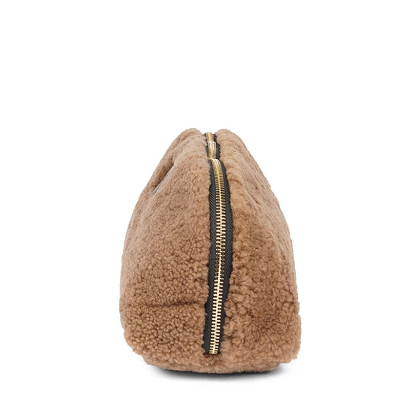 Lovelies Studio _ Wuttu is a mini clutch with a detachable wrist strap and is perfect for carrying your essentials with you. Wuttu is hand made from the finest curly shearling from Australia.   Top zipped closing   Detachable wrist strap   Satin lining and flat zipped inner pocket   Item comes with a branded dust bag.   Embossed Lovelies logo on the front   Gold-toned hardware   Measurements W26 X D2 X H12 cm   100 % Australian curly shearling 