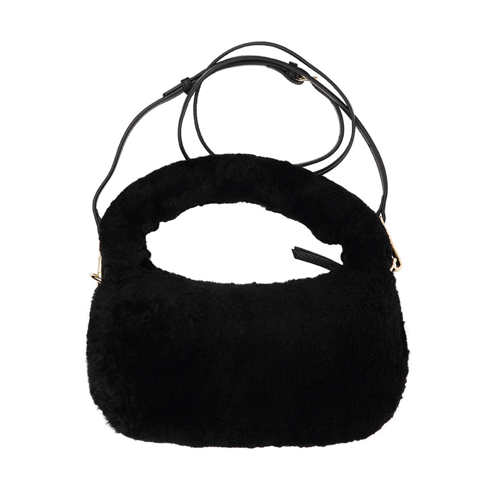 Lovelies Studio - Zhamo is a beautiful small shearling handbag which is perfect for carrying your essentials with you.  * Top handle in thick shearling   * Adjustable and detachable shoulder strap in leather   * Satin lining and flat zipped inner pocket   * Item comes with a branded dust bag.   * Gold-toned hardware   * Messurements W26 X D6 X H24 cm   * 100 % Australian shearling 